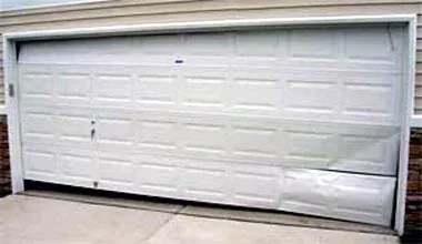 Damaged garage door section before replacement