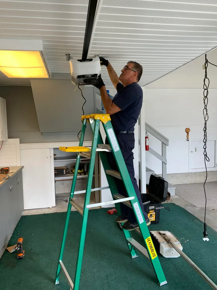 Ivan installing a garage door opener in a Langley home