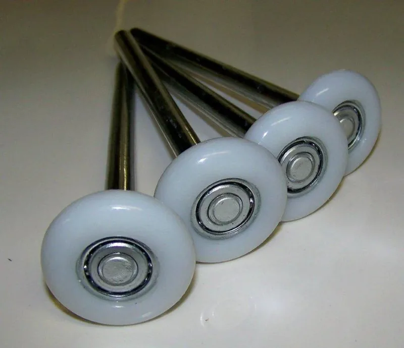 New nylon garage door rollers installed on a track